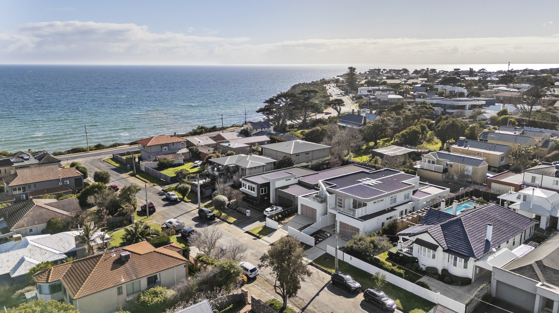 Aerial view of the coastline and neighbourhood beyond