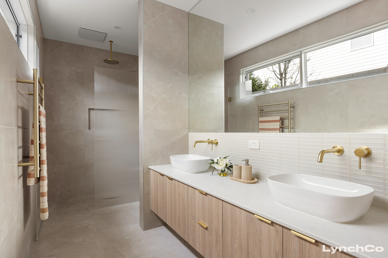 Bathroom with double vanity and brass tapware at 24A Ti-Tree Grove, Mornington