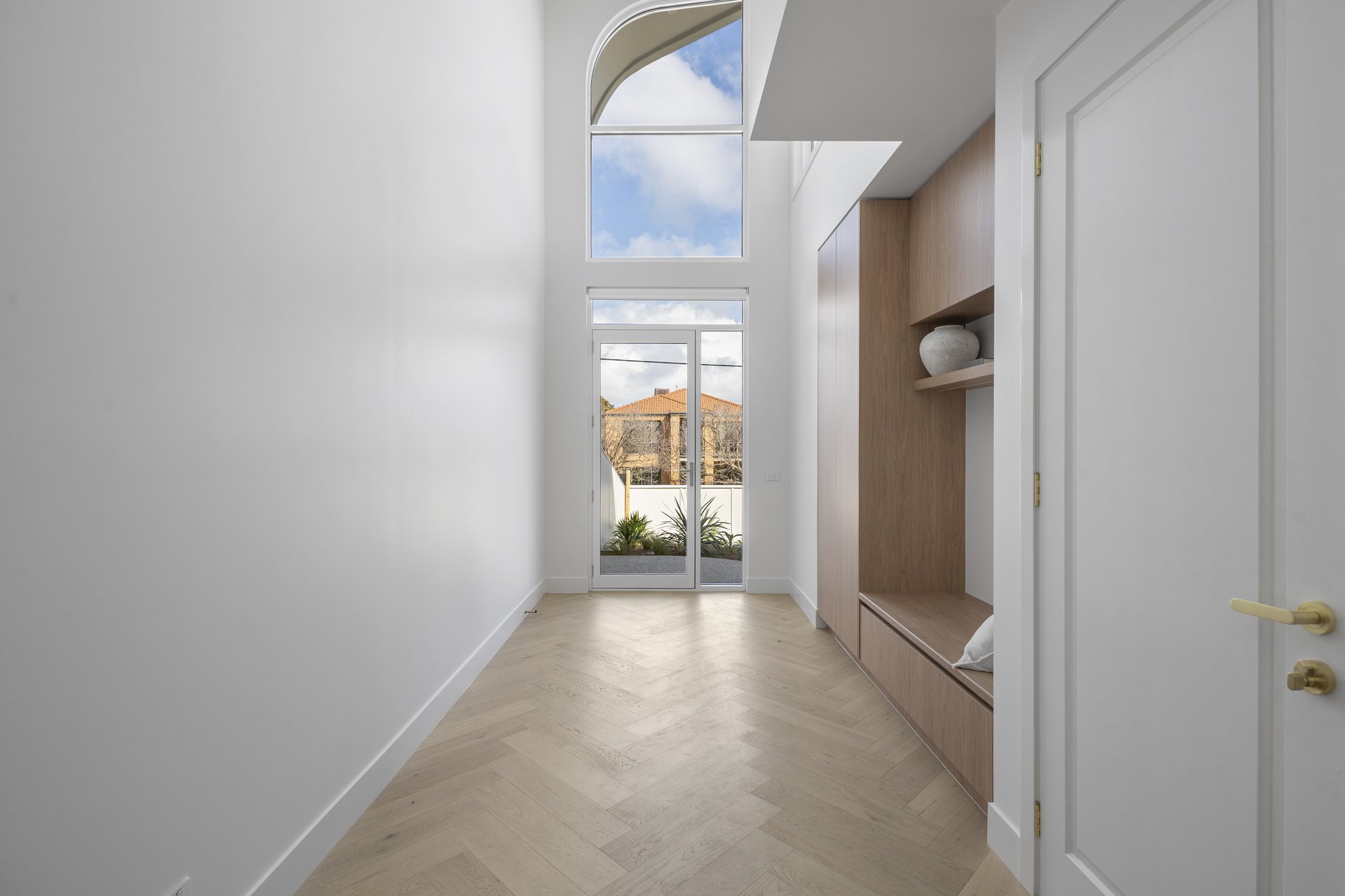 Entry hallway looking toward the arched front doorway