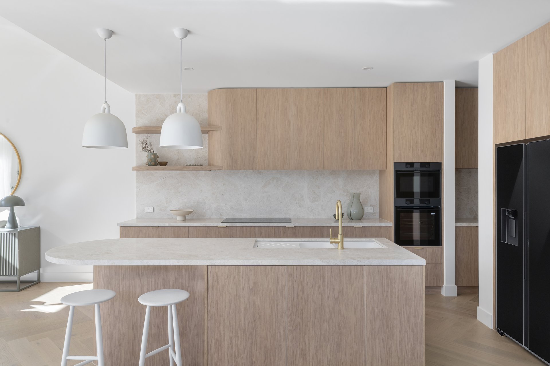 Kitchen with island bench, cabinetry and double ovens