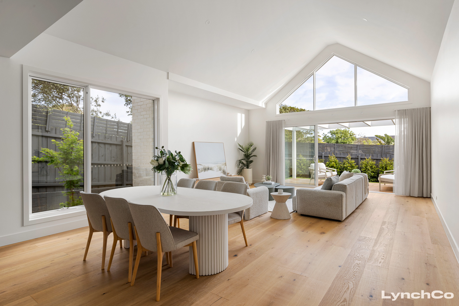 Open-plan dining and living with cathedral ceiling at 24A Ti-Tree Grove, Mornington